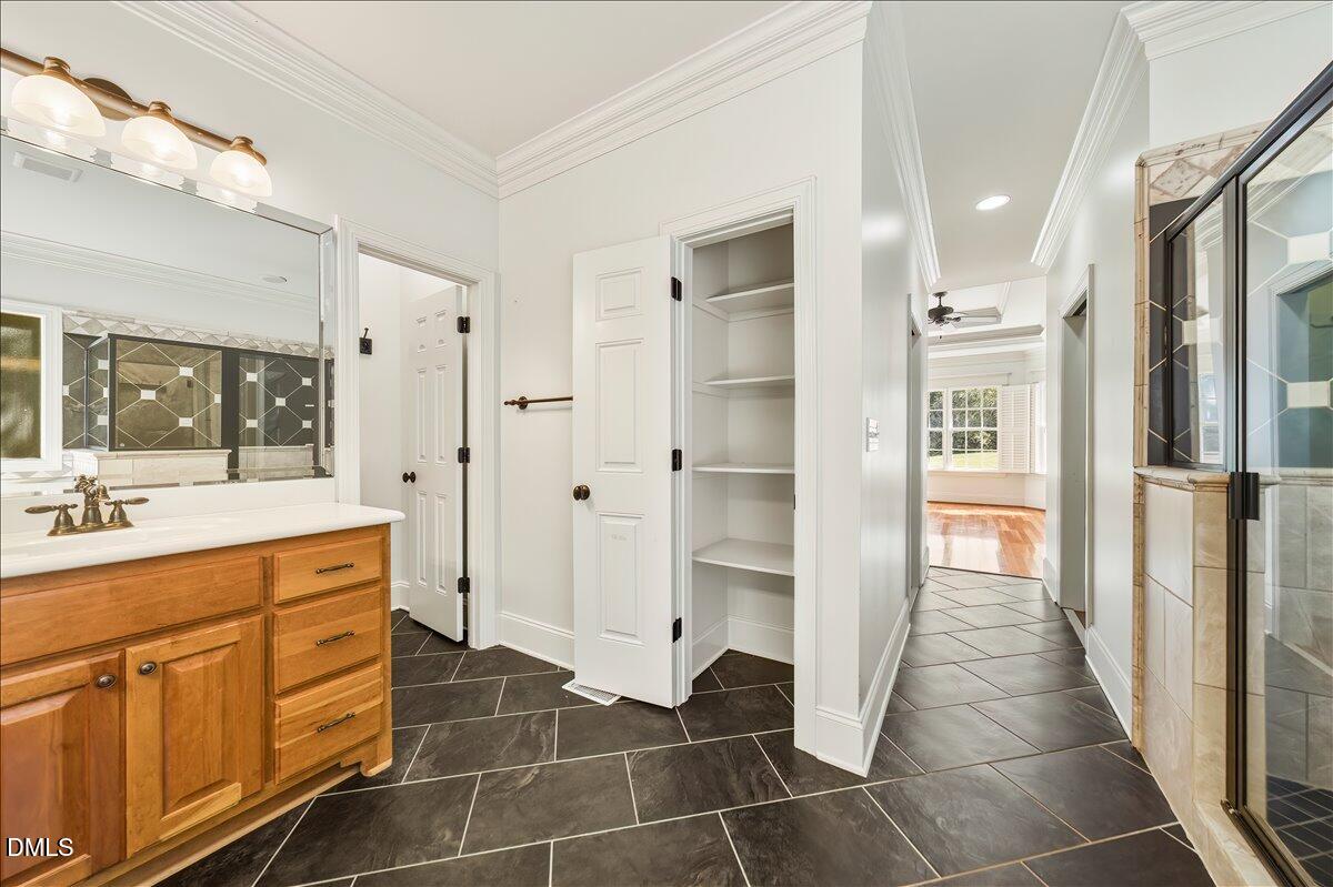 324 Waterville Street Raleigh, NC 27603 - Photo 38 of 82 a bathroom with a shower sink and mirror