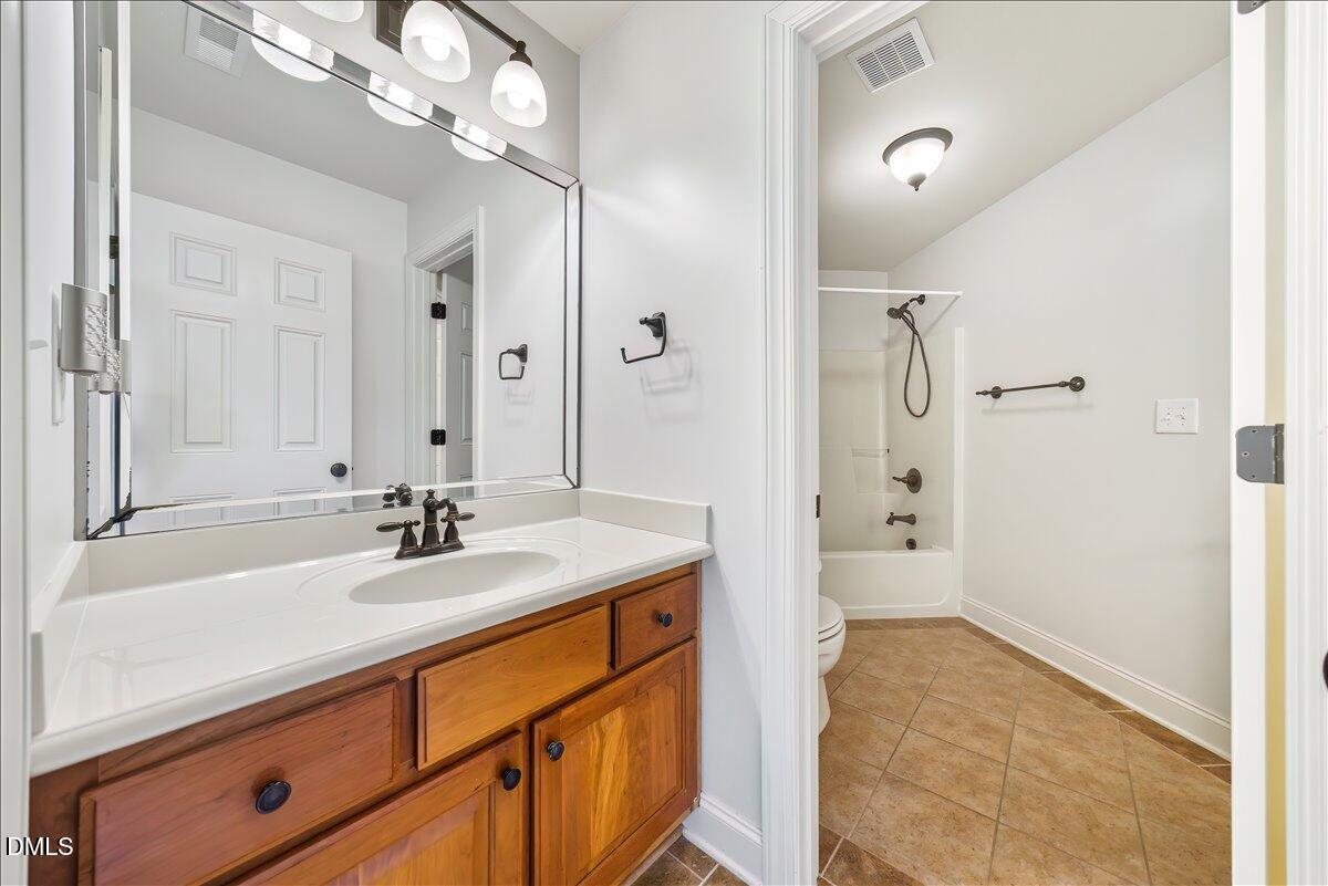324 Waterville Street Raleigh, NC 27603 - Photo 47 of 82 a bathroom with a sink a vanity and shower