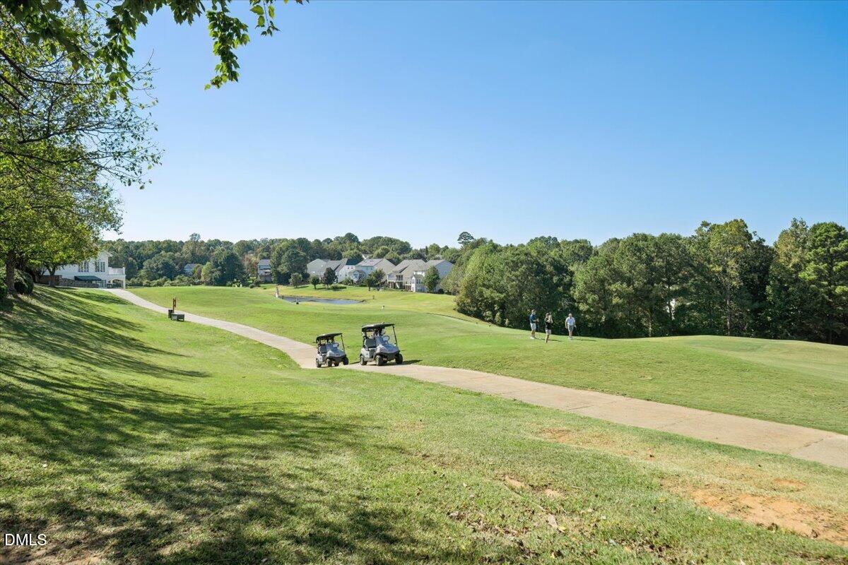 324 Waterville Street Raleigh, NC 27603 - Photo 7 of 82 a view of a golf course with a lake