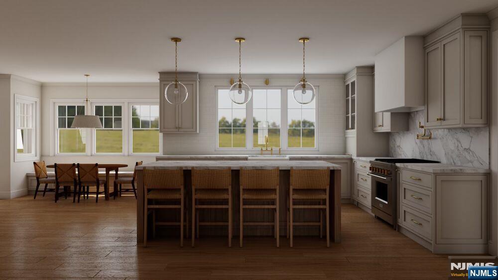 501 Sterling Place Ridgewood, NJ 07450 - Photo 4 of 5 a kitchen with stainless steel appliances granite countertop a stove a refrigerator a kitchen island a dining table and chairs with wooden floor