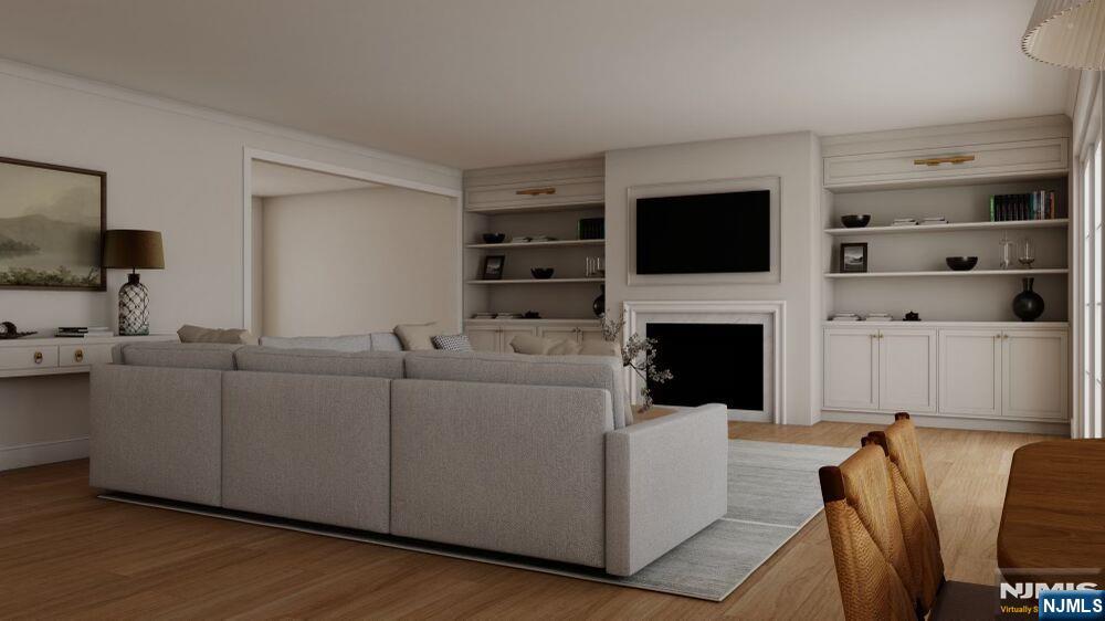 501 Sterling Place Ridgewood, NJ 07450 - Photo 5 of 5 a living room with furniture a flat screen tv and a fireplace