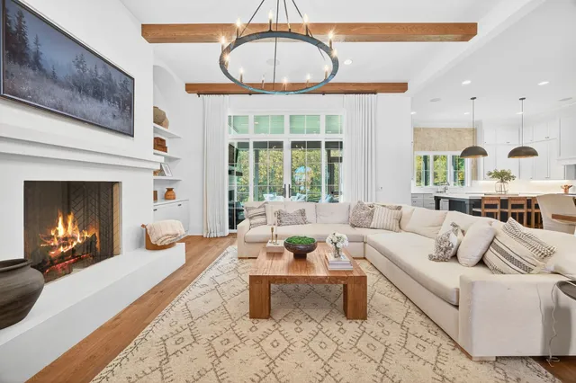 a kitchen with stainless steel appliances a stove and white cabinets