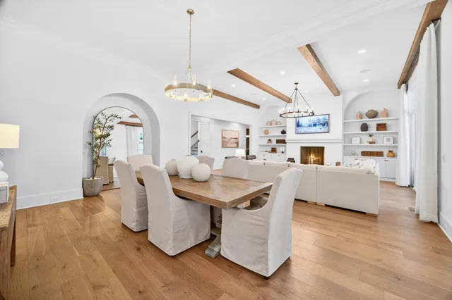 a living room with furniture a flat screen tv and a floor to ceiling window