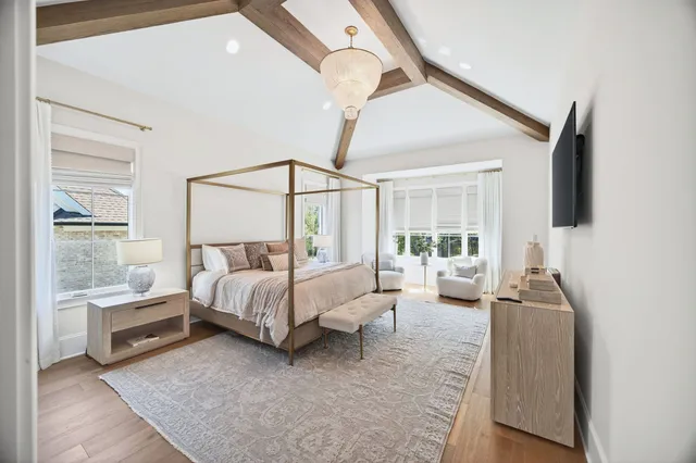 a dining room with furniture and painting on the wall