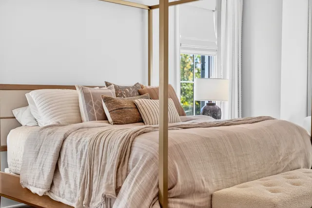 a living room with furniture fireplace and a large window