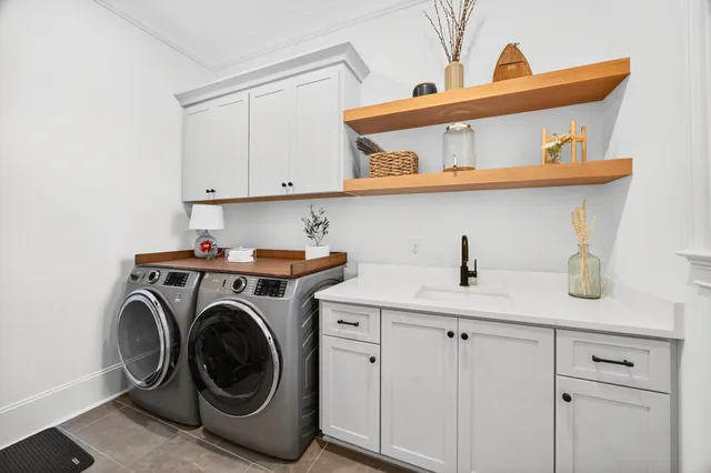 an aerial view of multiple houses with a lake view