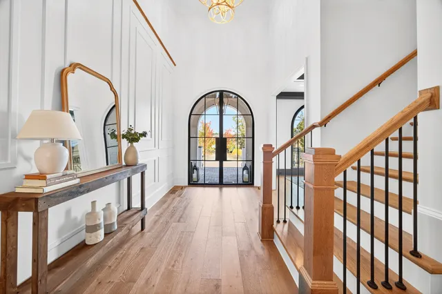 a kitchen with a table chairs and white cabinets