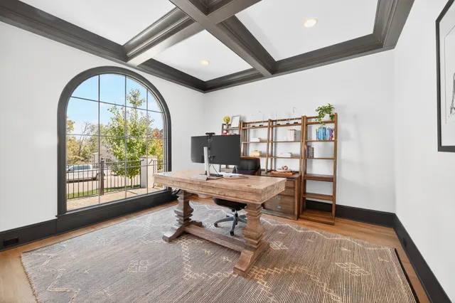 a large kitchen with kitchen island granite countertop a large window and a sink