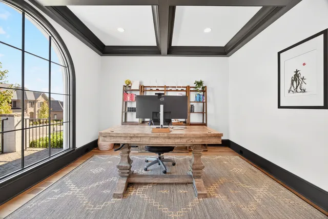 a kitchen with stainless steel appliances granite countertop a stove a sink a oven a dining table and chairs with wooden floor