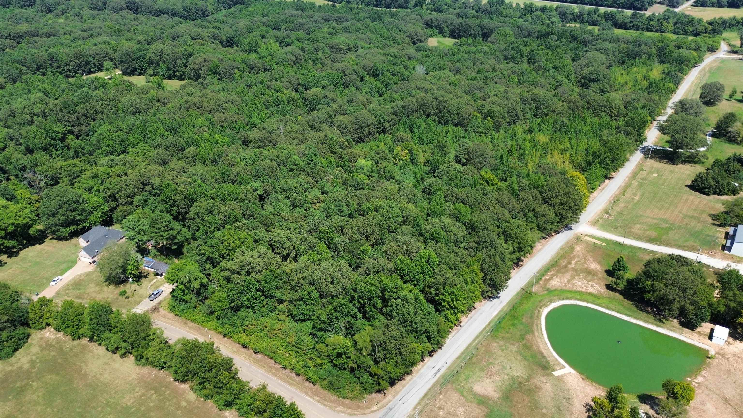 2730 Price Road Moscow, TN 38057 - Photo 1 of 5 Aerial view of property's location with a heavily wooded area and a nearby body of water
