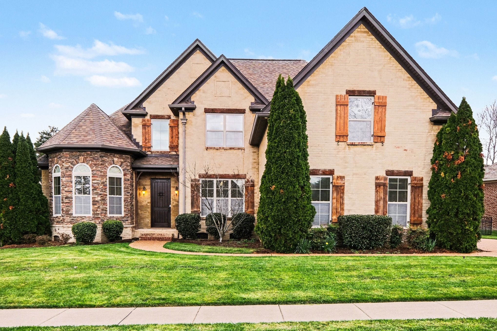 a front view of a house with a yard