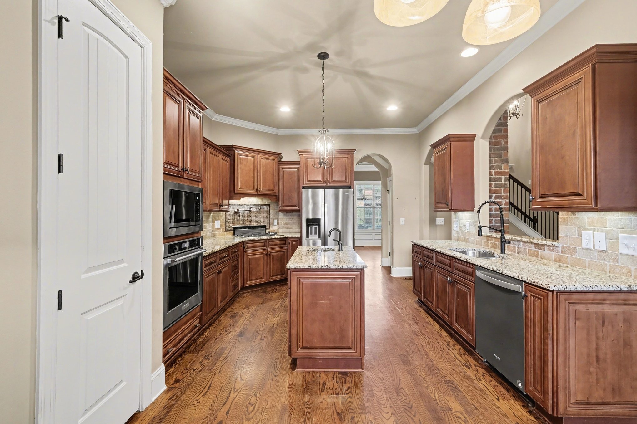 1017 Alice Springs Circle Spring Hill, TN 37174 - Photo 13 of 35 a large kitchen with stainless steel appliances granite countertop a lot of counter space wooden floor and stainless steel appliances
