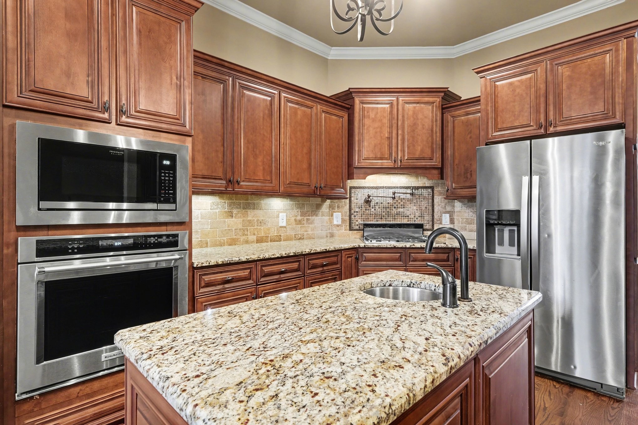 1017 Alice Springs Circle Spring Hill, TN 37174 - Photo 14 of 35 a kitchen with kitchen island granite countertop a refrigerator stove and sink