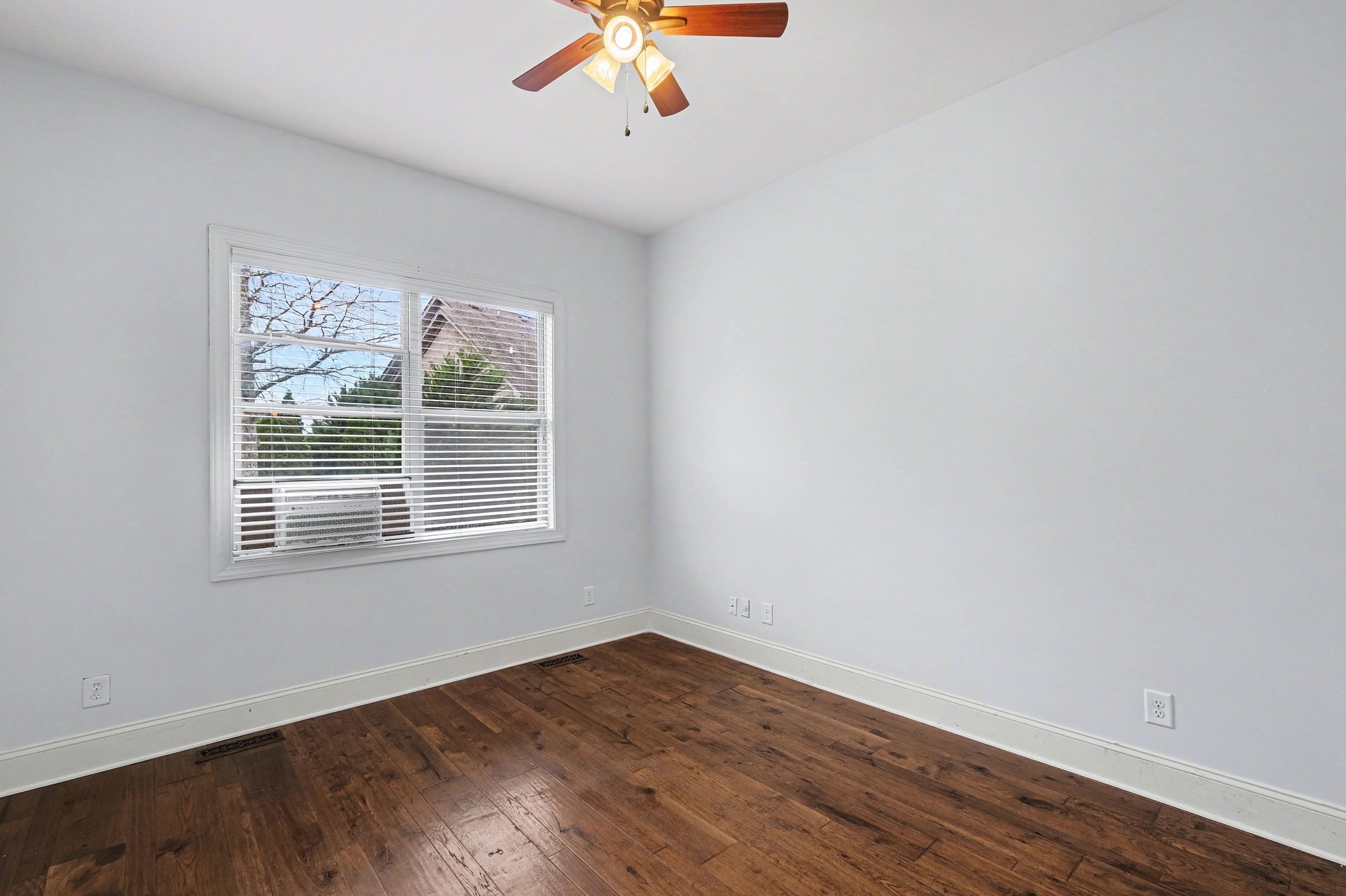 1017 Alice Springs Circle Spring Hill, TN 37174 - Photo 22 of 35 an empty room with wooden floor and windows