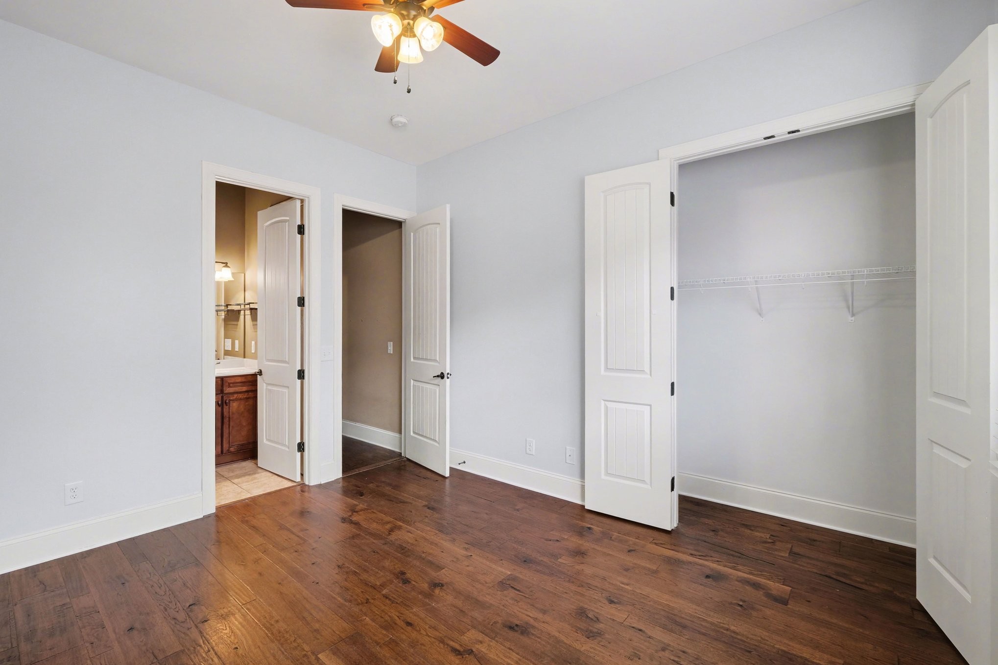 1017 Alice Springs Circle Spring Hill, TN 37174 - Photo 23 of 35 an empty room with wooden floor and ceiling fan