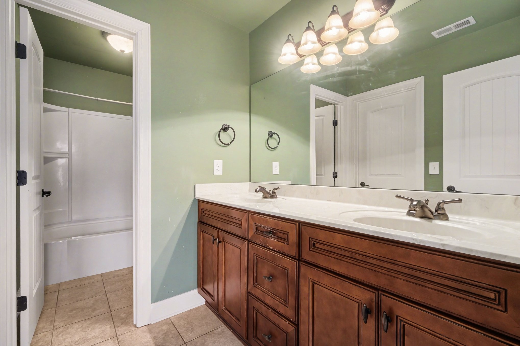1017 Alice Springs Circle Spring Hill, TN 37174 - Photo 30 of 35 a bathroom with a double vanity sink and a mirror