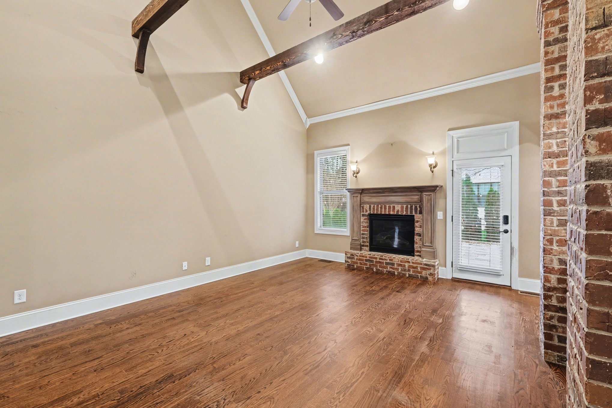 1017 Alice Springs Circle Spring Hill, TN 37174 - Photo 8 of 35 a view of an empty room with wooden floor fireplace and a window