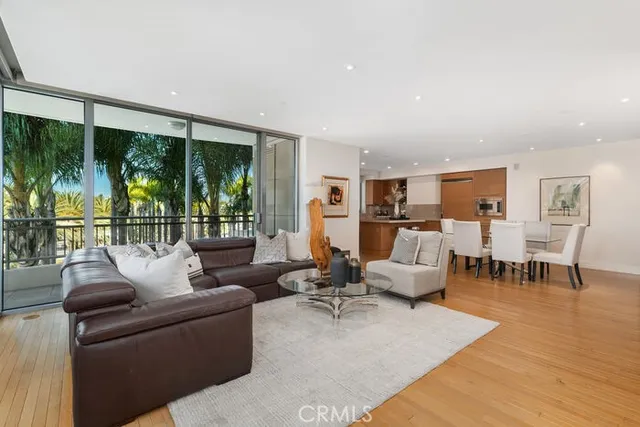 a living room with furniture and large windows