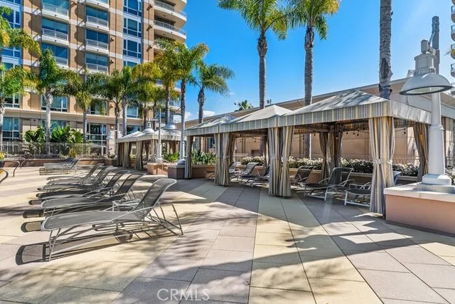 a view of a patio with a dining table and chairs under an umbrella