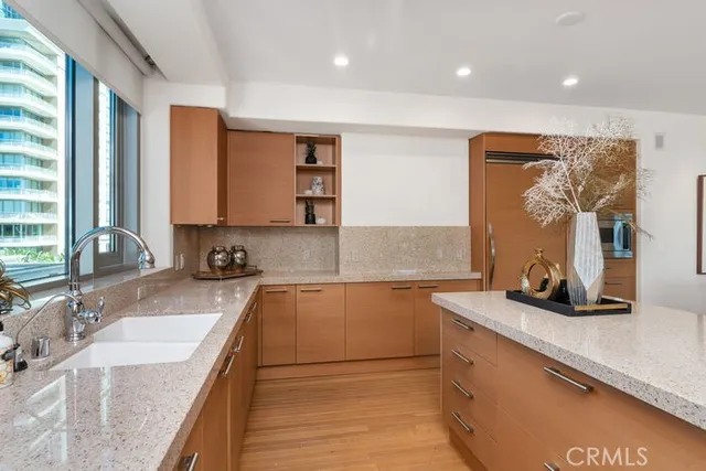 a kitchen with stainless steel appliances granite countertop a sink stove and cabinets