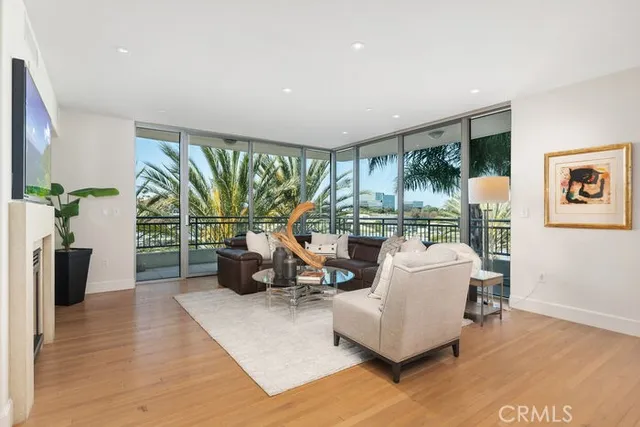a living room with furniture and a floor to ceiling window