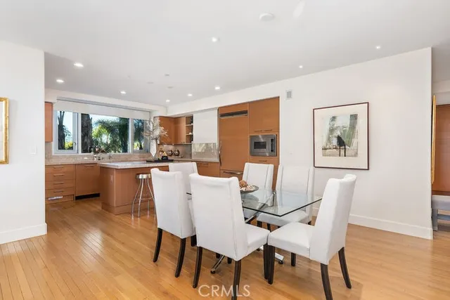 a dining room with furniture window and wooden floor