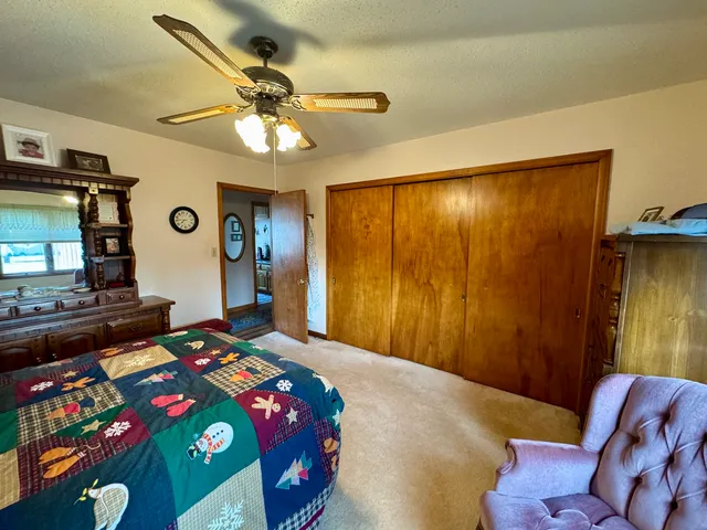 a work room with furniture bookshelf and a window