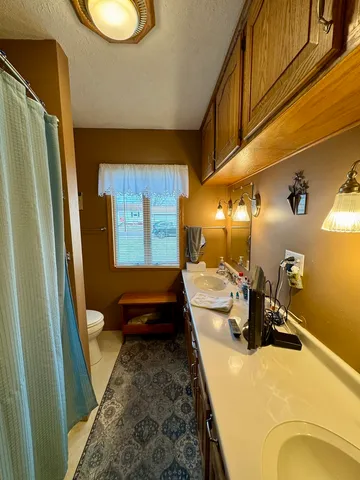 a living room with furniture fireplace and large window