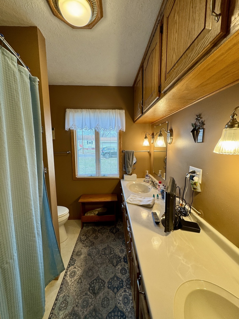 113 West 3rd Street Wyanet, IL 61379 - Photo 16 of 31 a bedroom with a bed and wooden floor