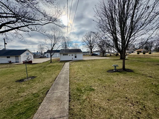 a bedroom with a bed couch and a window
