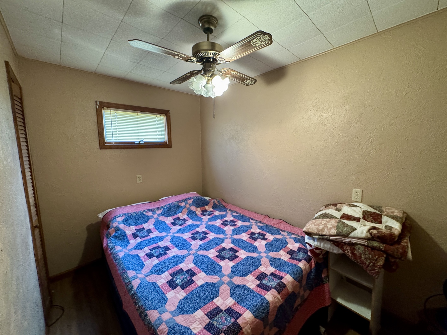 113 West 3rd Street Wyanet, IL 61379 - Photo 28 of 31 a bedroom with a bed and a chandelier
