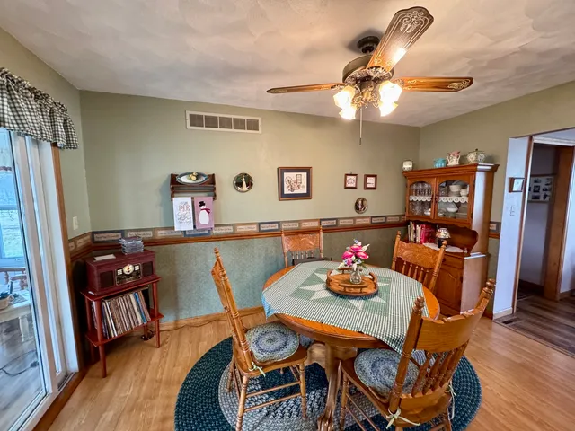 a view of a dining room with furniture and wooden floor