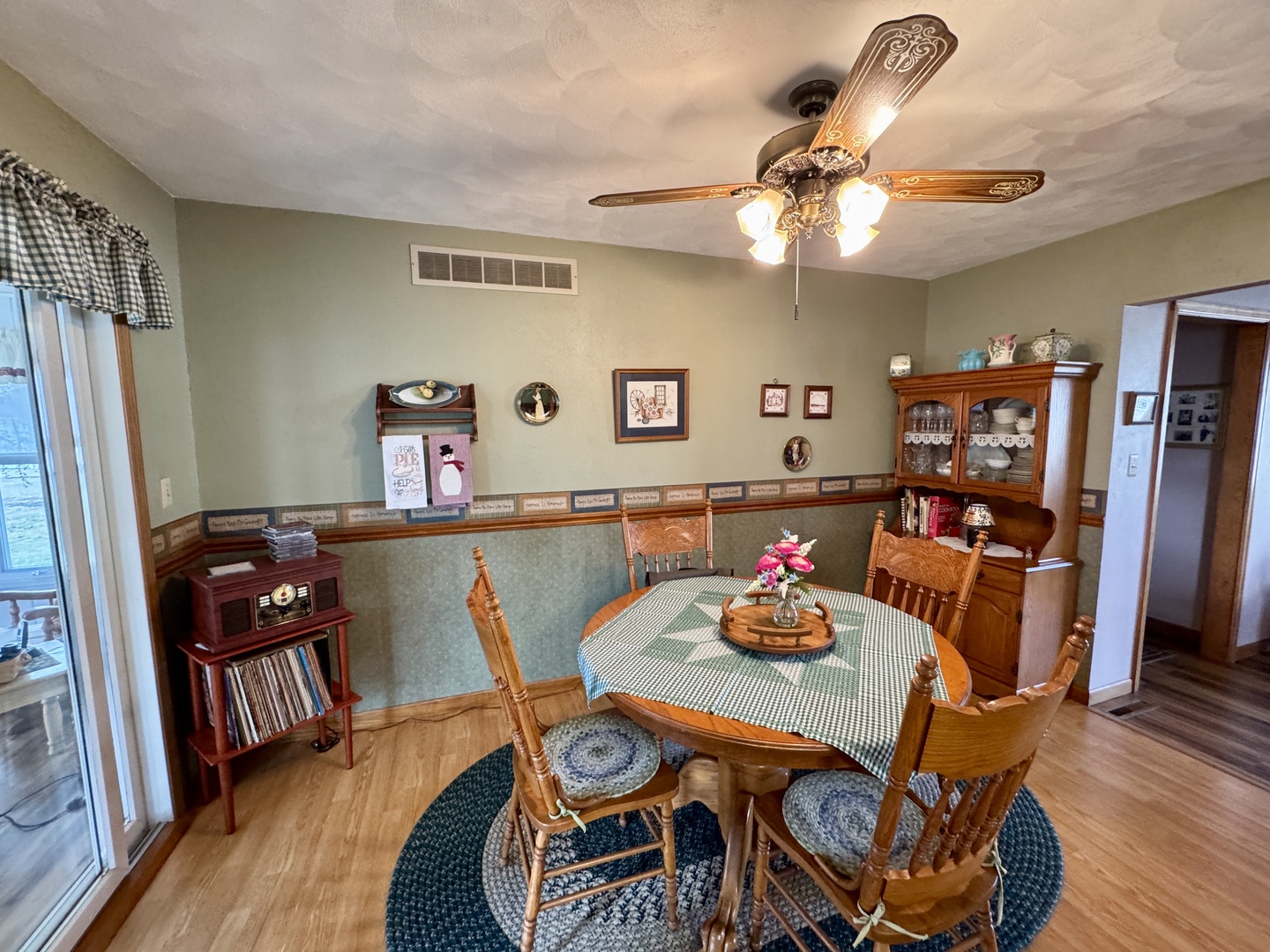 113 West 3rd Street Wyanet, IL 61379 - Photo 6 of 31 a view of a dining room with furniture and wooden floor