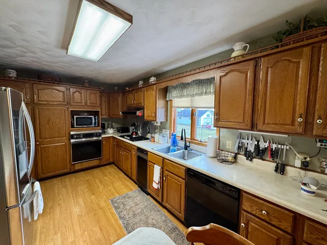 a kitchen with stainless steel appliances granite countertop a sink stove and cabinets