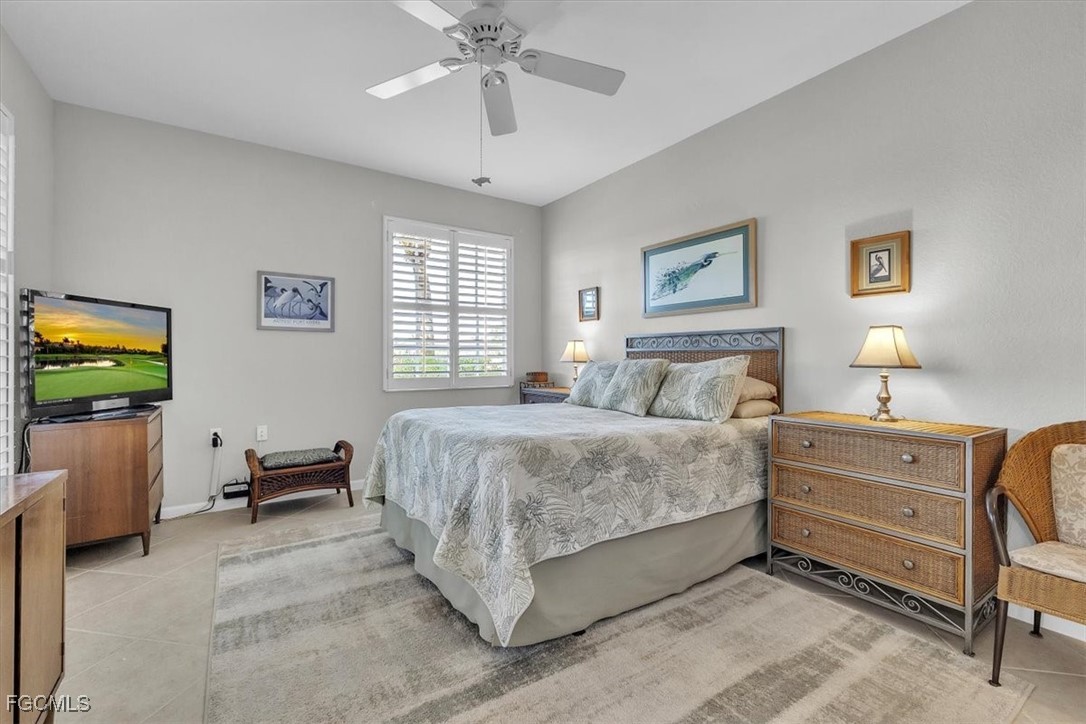3711 Pebblebrook Ridge Court, Unit 101 Fort Myers, FL 33905 - Photo 18 of 50 a spacious bedroom with a bed and a chandelier