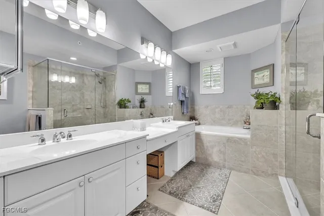a bathroom with a double vanity sink mirror double and shower