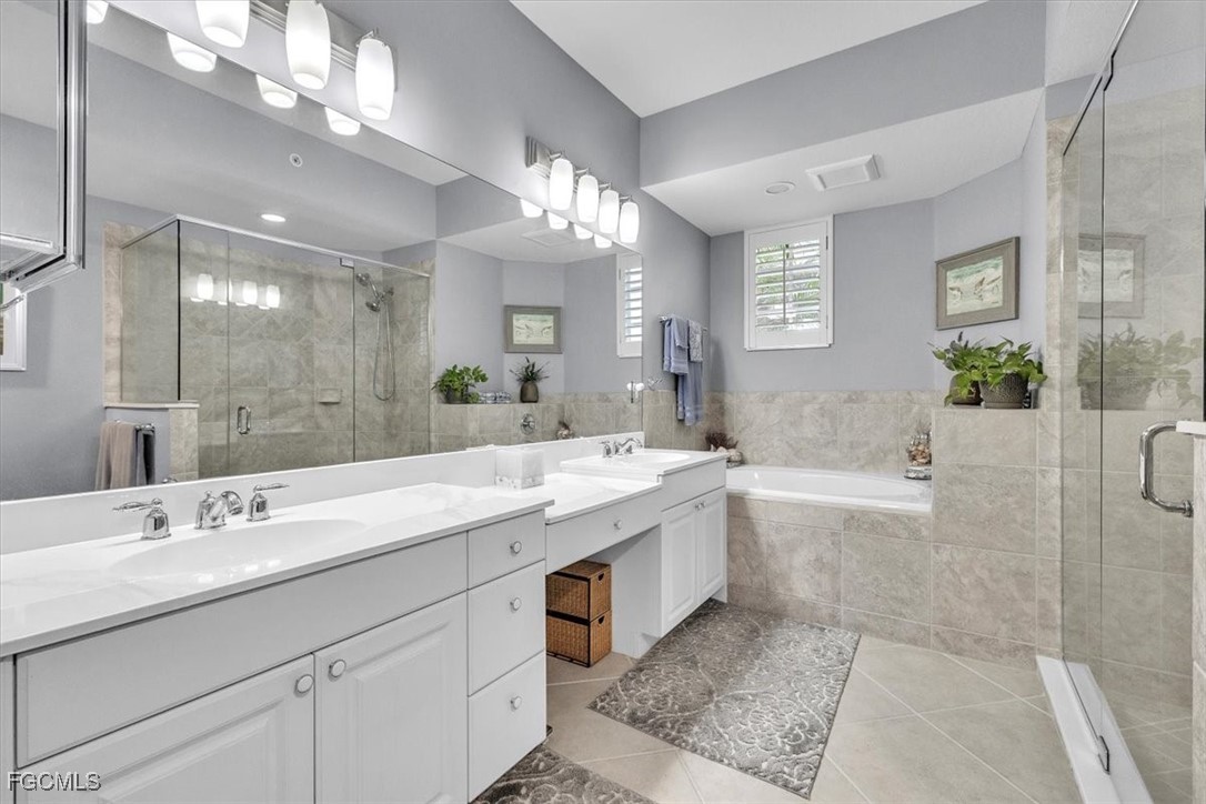 3711 Pebblebrook Ridge Court, Unit 101 Fort Myers, FL 33905 - Photo 22 of 50 a spacious bathroom with a bathtub shower sink double and mirror