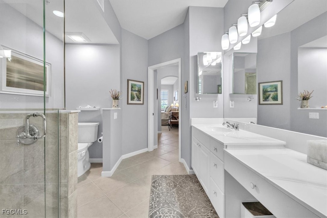 3711 Pebblebrook Ridge Court, Unit 101 Fort Myers, FL 33905 - Photo 25 of 50 a bathroom with a double vanity sink mirror and shower