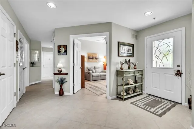 a living room with furniture a flat screen tv and a large window