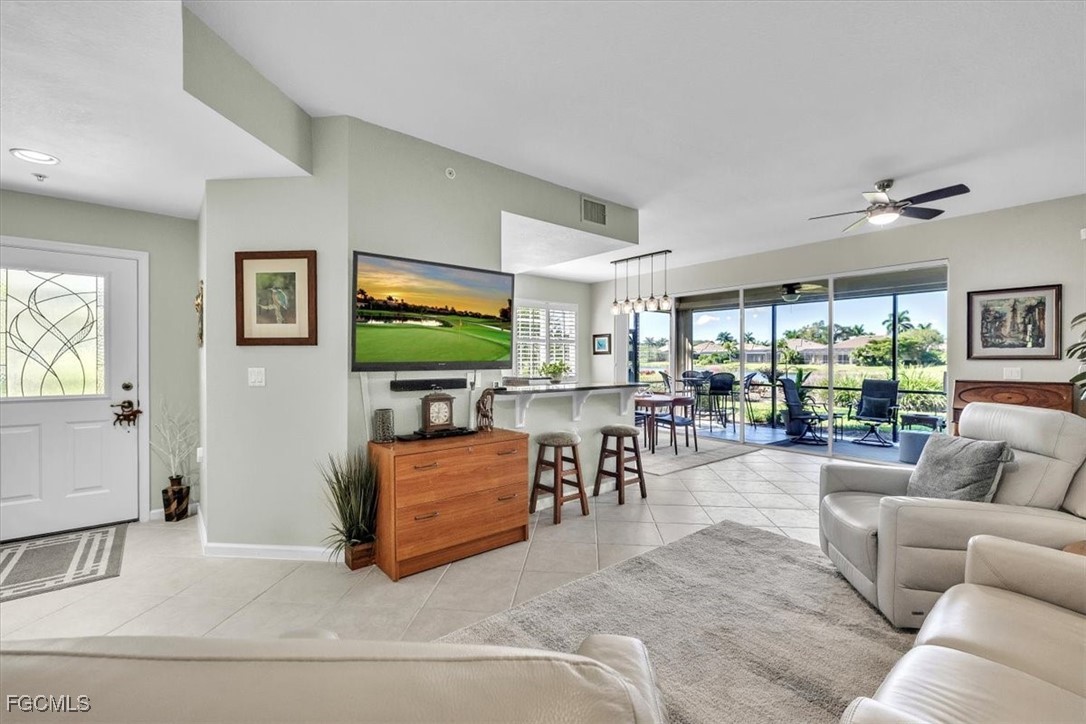 3711 Pebblebrook Ridge Court, Unit 101 Fort Myers, FL 33905 - Photo 8 of 50 a living room with furniture and a flat screen tv