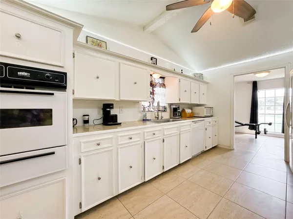 a kitchen with cabinets and appliances
