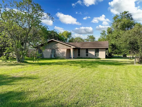 a front view of house with outdoor space and swimming pool