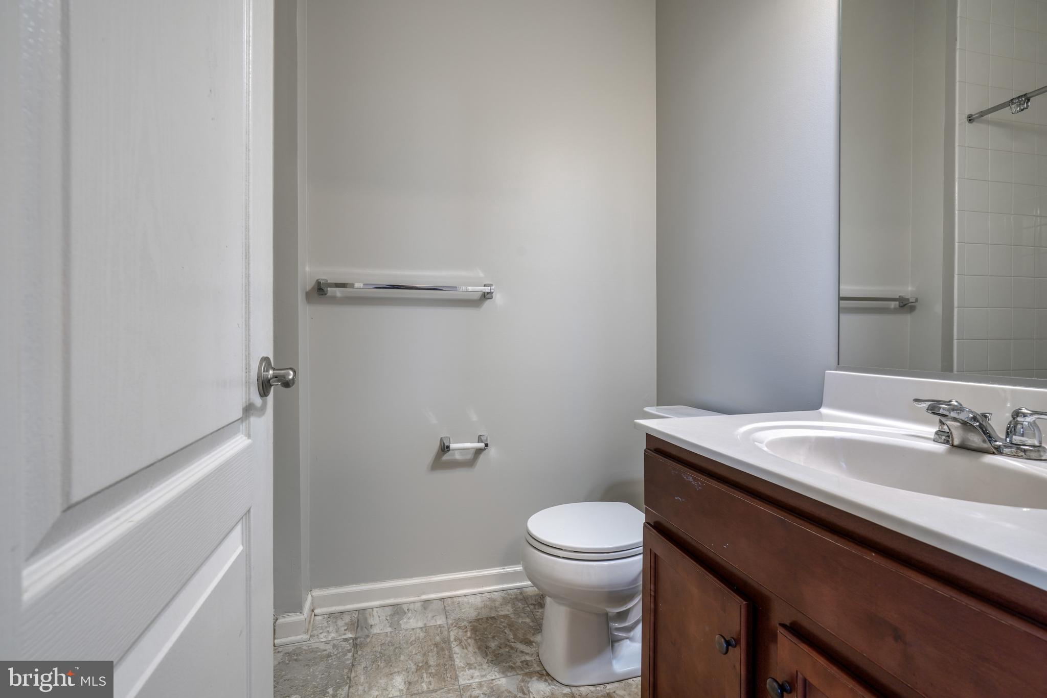 985 Morgan Run Road Middle River, MD 21220 - Photo 30 of 33 a bathroom with a granite countertop sink toilet and a mirror