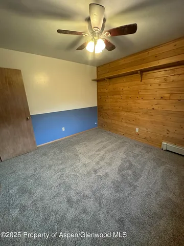 a bathroom with a granite countertop toilet sink and mirror