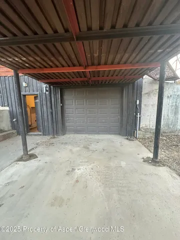 a backyard of a house with barbeque oven