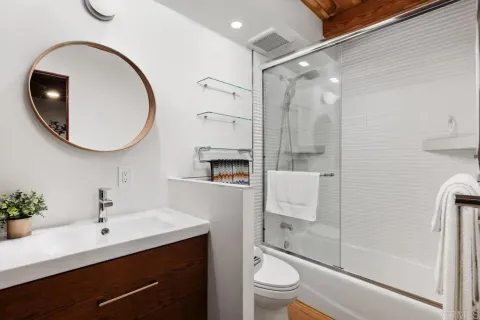 a bedroom with bed and wooden floor