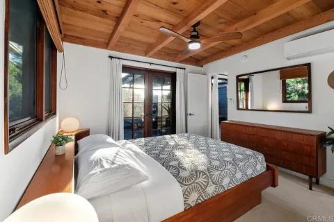 a bedroom with two beds and painted walls