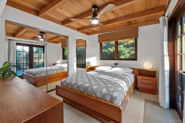 a bedroom with bed and wooden floor