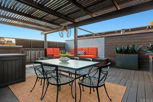 a view of a patio with table and chairs under an umbrella