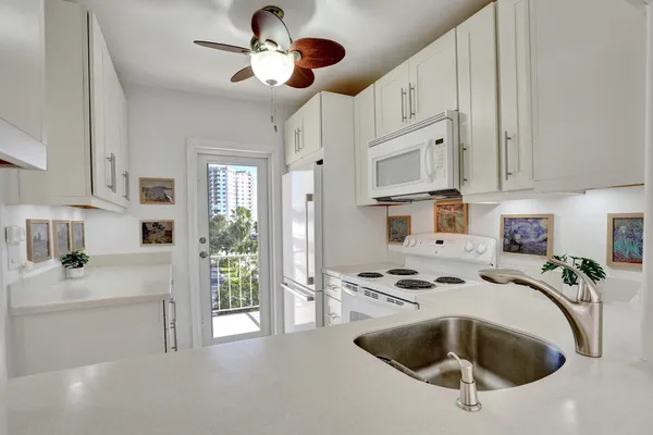 a kitchen with stainless steel appliances kitchen island granite countertop a sink and cabinets